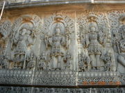 Temple carving at Hoysaleswara temple representing the Trimurti: Brahma, Siva and Vishnu.