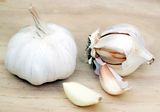 Garlic bulbs and individual cloves, one peeled.