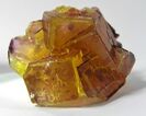 A golden yellow with hints of purple fluorite