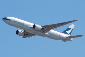 Front quarter view of a Cathay Pacific 777 in flight with flaps and landing gear retracted