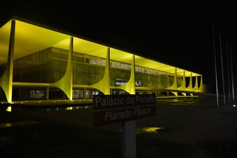 The Palácio do Planalto, official workplace of the President of Brazil, illuminated in yellow light.