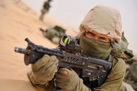 An Israel Defense Forces soldier of the unisex Caracal Battalion armed with IWI Tavor assault rifle with Meprolight 21 reflex sight.