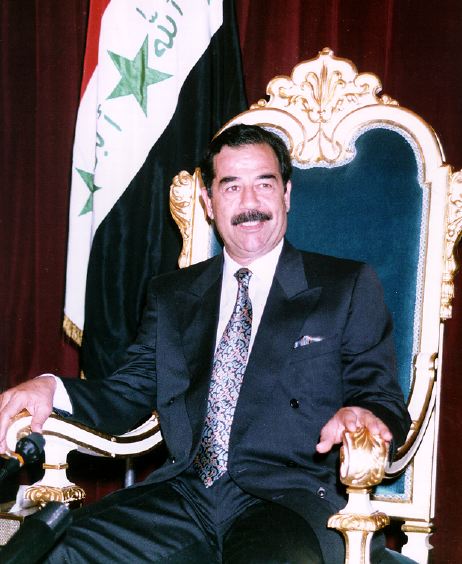 ملف:Saddam Hussein on his throne.jpg