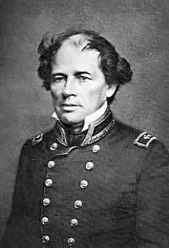 Photograph of a man, seated, in double-breasted naval uniform