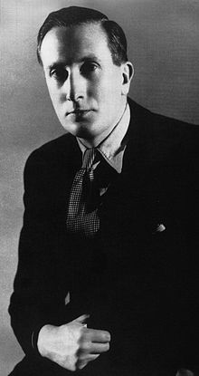 Young man in suit and tie looking towards the camera