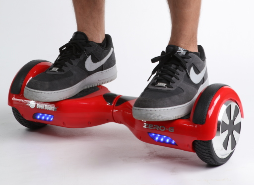 ملف:Red self-balancing two-wheeled board with a person standing on it.png