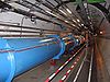 Image of the CERN Large Hadron Collider featuring the main pipe and tracks for transports.