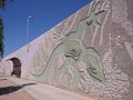 A 67-foot concrete lizard basks in the sun, featured on a sound/retaining wall in Scottsdale, AZ.