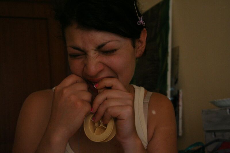 ملف:Woman biting adhesive tape.jpg