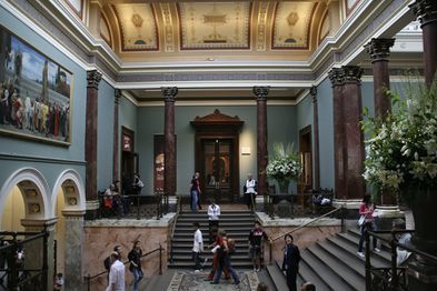 The Staircase Hall, designed by Sir John Taylor in 1884–7. Cimabue's Celebrated Madonna by Frederic, Lord Leighton is visible to the left.
