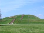 A large earthen mound with steps leading to the top