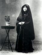 Macanese senhora wearing the traditional Macanese dress, the dó