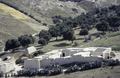 A white farm seen from above with a typical white washed triangular haystack, 1997.