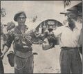 Commonwealth soldiers pose with a decapitated head inside a British military base in Malaya during the Malayan Emergency