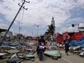 Palu residents make their way along a street full of debris on September 29.jpg