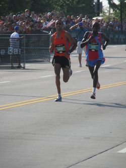 The final 200 meters of the 2007 Chicago Marathon was a shoulder to shoulder race between Patrick Ivuti (right) and Gharib (left).
