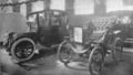 Electric car and antique car on display at a 1912 auto show in Toronto