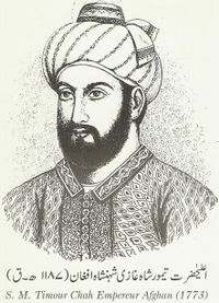 A black and white portrait, from the chset up, of a bearded and turbaned man