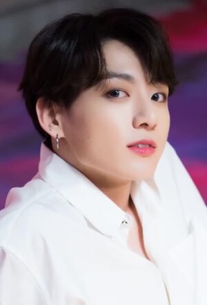 Jungkook looks up to the right, against a purple background