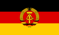 The flag of East Germany (1959–90). It differs from the West German flag by the presence of a communist symbol in the center, and it fell out of use when Germany was reunified after the fall of the Berlin Wall.