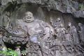 Maitreya and disciples in budai form, as depicted at the Feilai Feng grottos near Lingyin Temple in Hangzhou, China