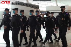 Policemen wearing masks patrolling Wuhan Tianhe Airport during Wuhan coronavirus outbreak.jpg