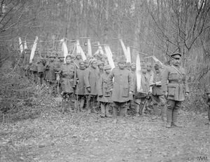 Black and white photograph of a group of men with saws in a forest