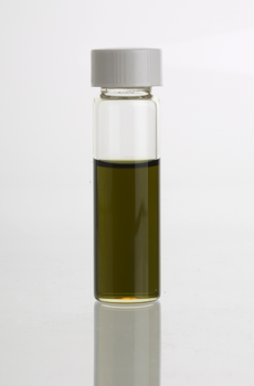 A vial containing the dark green-brownish essential oil