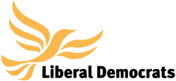 Bird in flight made from curving yellow lines above text "Liberal Democrats" in black sans-serif text.