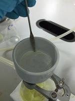 This is one of many uses of stainless steel spatula: it can be used to aid the removal of filter paper from vacuum filtration.