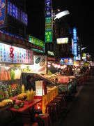 A picture showing market food stalls by night.