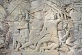 Cham soldier in helmet fighting Khmer soldier, Bas-relief at Bayon temple in Cambodia