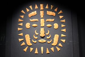 Fifty small pieces, including some carved in the shapes of individual features of a face