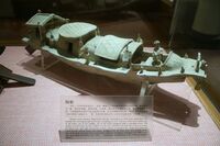 An Eastern Han dynasty pottery boat model with a steering rudder at the stern and anchor at the bow.
